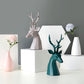 Two deer figurine tabletop and a vase